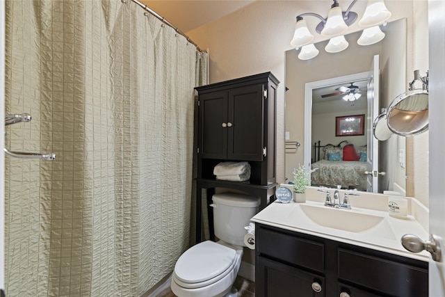 bathroom featuring ceiling fan, toilet, and vanity