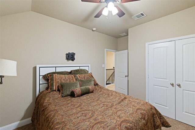 bedroom with carpet flooring, ceiling fan, lofted ceiling, and a closet