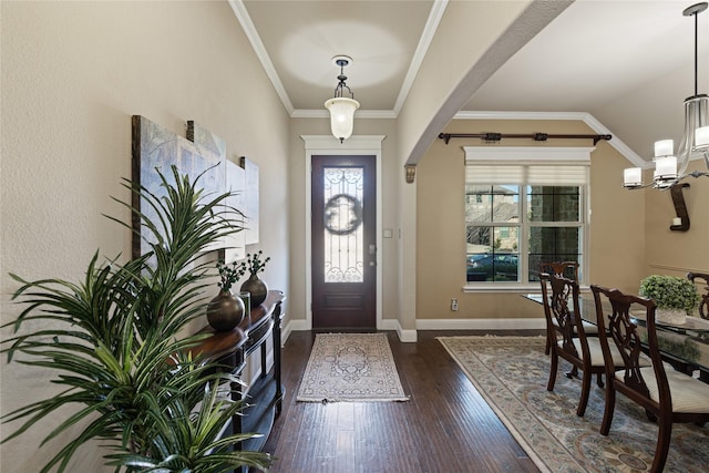 foyer entrance featuring crown molding, dark hardwood / wood-style floors, and lofted ceiling