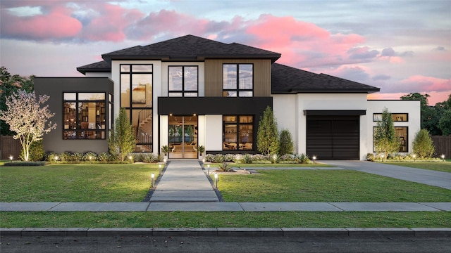 contemporary house with a garage and a yard