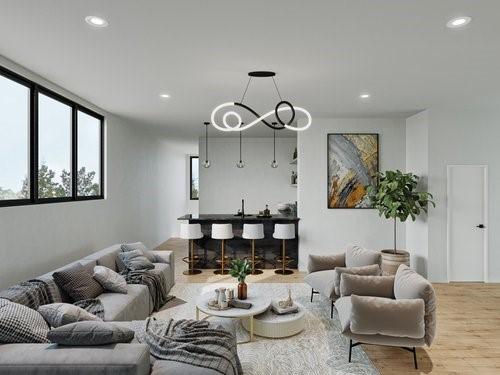 living room featuring wood-type flooring and an inviting chandelier