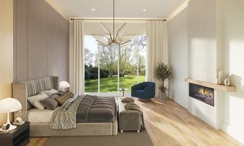 bedroom with a large fireplace and a chandelier