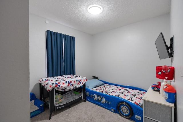 carpeted bedroom featuring a textured ceiling