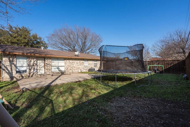 view of yard featuring a trampoline and a patio area