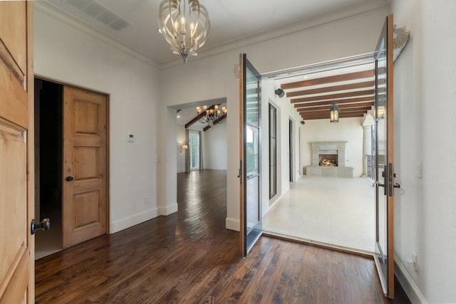 corridor featuring crown molding, dark hardwood / wood-style floors, beam ceiling, and an inviting chandelier