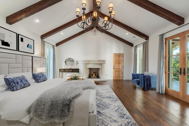 bedroom featuring a fireplace, an inviting chandelier, vaulted ceiling with beams, and french doors