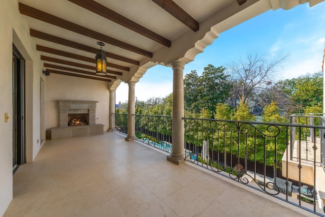 balcony featuring a fireplace