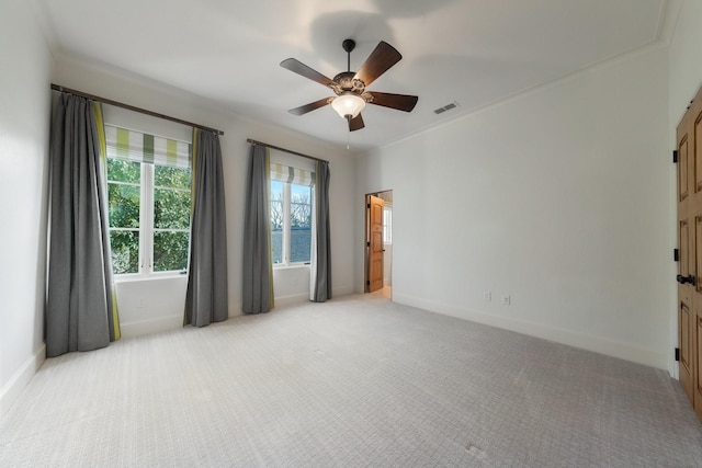 carpeted empty room with crown molding and ceiling fan