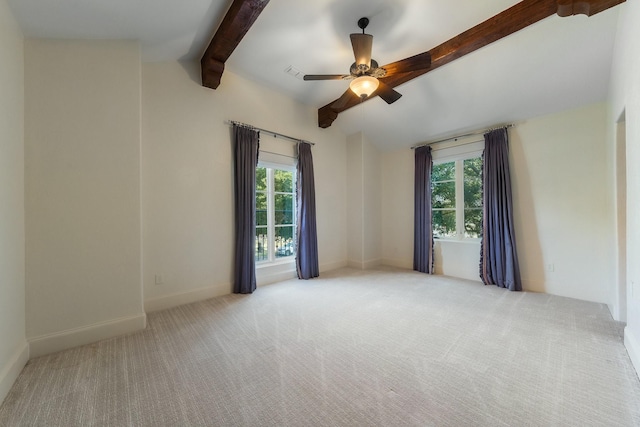 carpeted spare room with ceiling fan and vaulted ceiling with beams