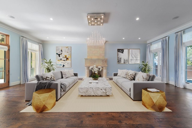 living room with hardwood / wood-style flooring, a large fireplace, and crown molding