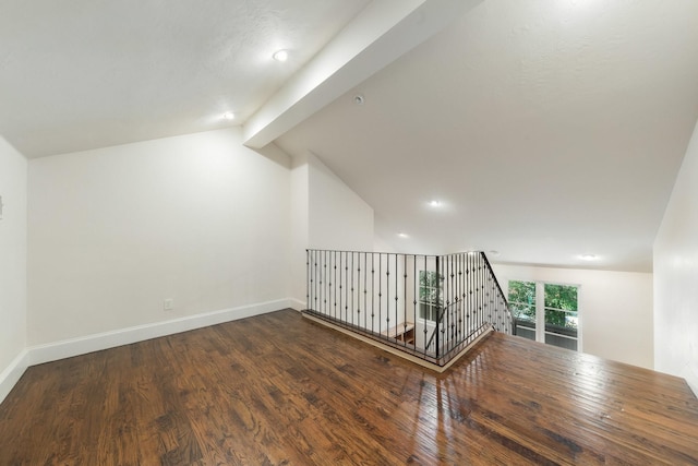 bonus room with hardwood / wood-style floors and lofted ceiling with beams