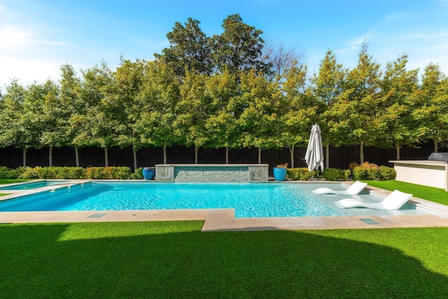 view of pool with a yard