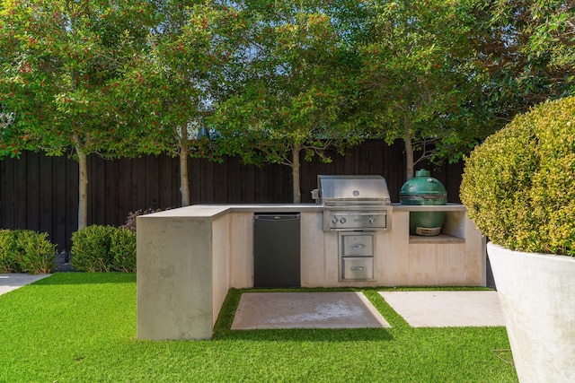 view of patio featuring exterior kitchen and a grill