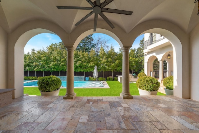 view of patio featuring a balcony, a fenced in pool, and ceiling fan