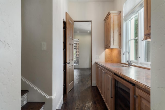 corridor featuring sink, dark hardwood / wood-style floors, and wine cooler