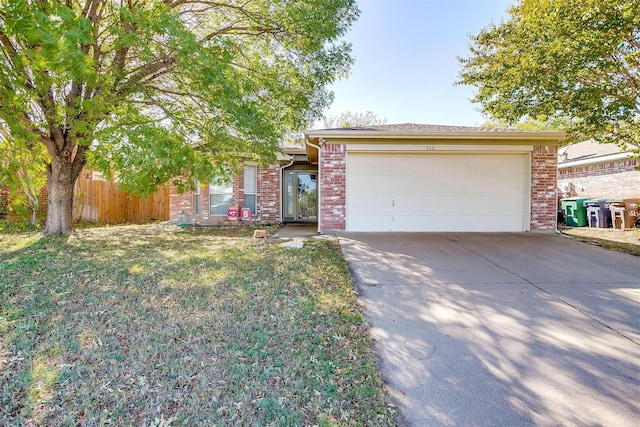 view of front of house featuring a garage and a front lawn