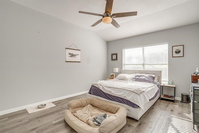 bedroom featuring light hardwood / wood-style flooring, ceiling fan, and lofted ceiling