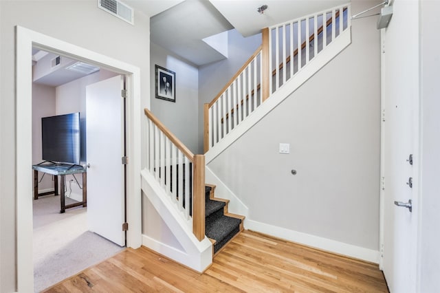 staircase featuring wood-type flooring