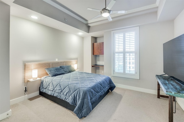 bedroom featuring light carpet, a raised ceiling, and ceiling fan