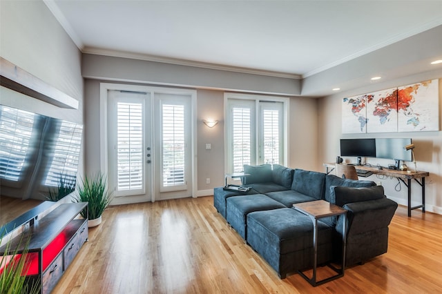 living room featuring french doors, hardwood / wood-style flooring, and crown molding