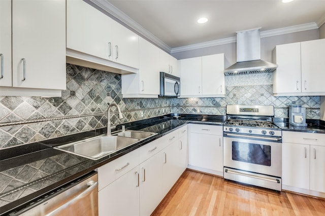 kitchen with white cabinets, sink, wall chimney exhaust hood, and appliances with stainless steel finishes