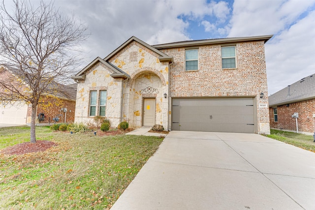 view of front of property featuring a garage and a front yard