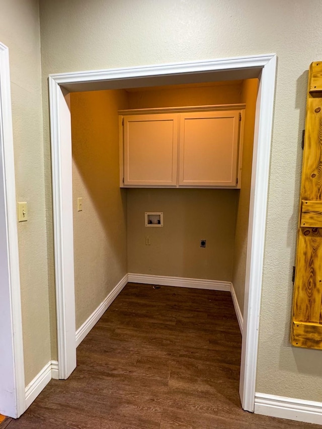 laundry area featuring electric dryer hookup, dark wood-type flooring, hookup for a washing machine, and cabinets