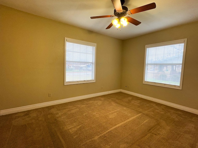 spare room with carpet flooring and ceiling fan