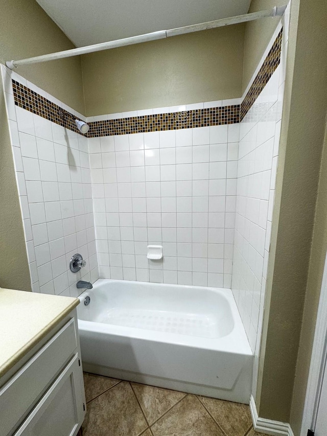 bathroom featuring vanity, tile patterned floors, and tiled shower / bath