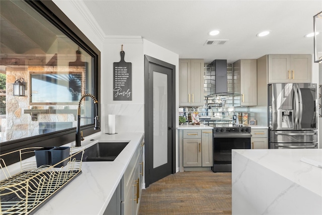 kitchen with stainless steel refrigerator with ice dispenser, sink, gray cabinetry, electric range oven, and wall chimney range hood