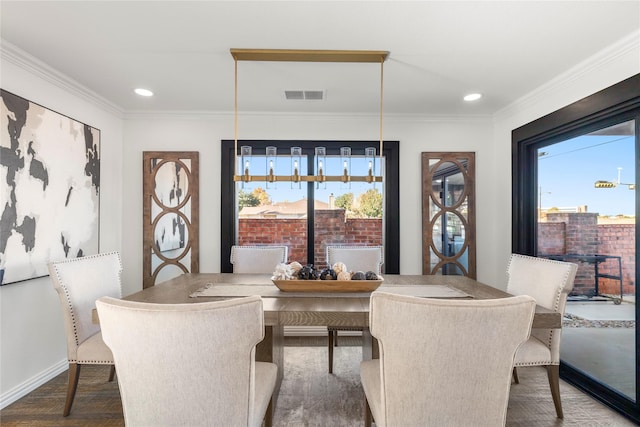 dining room with hardwood / wood-style flooring and ornamental molding