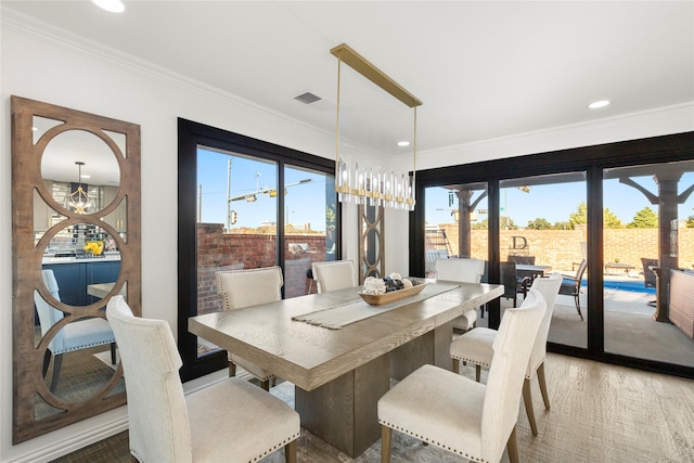 dining area featuring crown molding and a notable chandelier