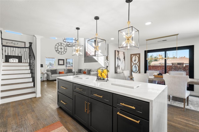 kitchen with a kitchen island, dark wood-type flooring, pendant lighting, and a chandelier