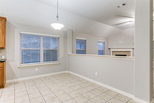 unfurnished dining area featuring vaulted ceiling