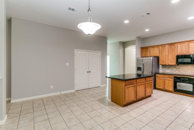 kitchen with black appliances, hanging light fixtures, light tile patterned floors, a kitchen island, and backsplash