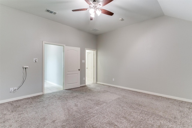 carpeted empty room with vaulted ceiling and ceiling fan