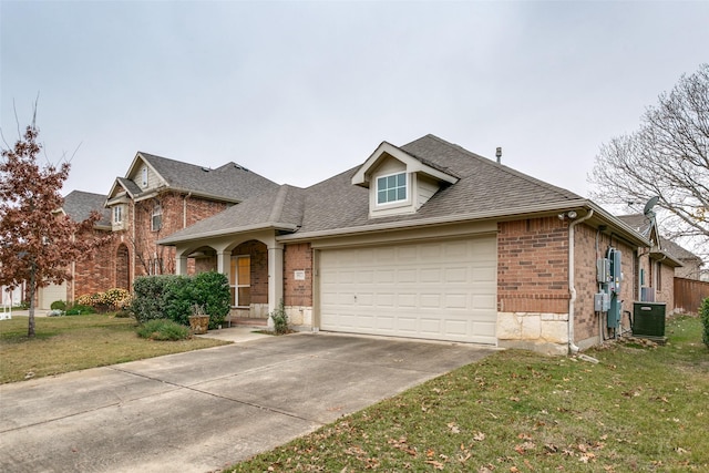 view of front facade featuring central AC, a front lawn, and a garage