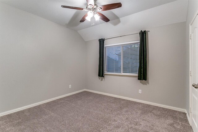 spare room with vaulted ceiling, ceiling fan, and carpet flooring