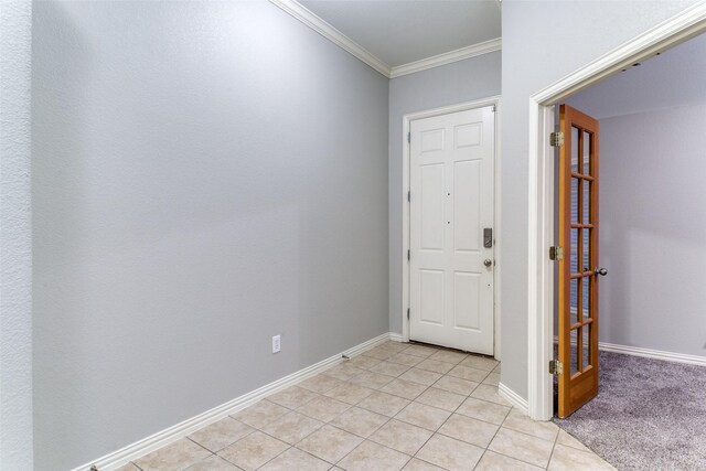 foyer entrance with crown molding and light colored carpet