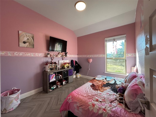 bedroom with lofted ceiling and parquet floors