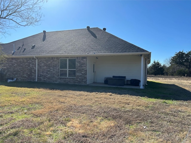 back of house featuring a yard