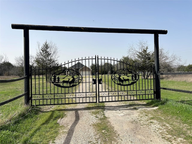 view of gate with a rural view