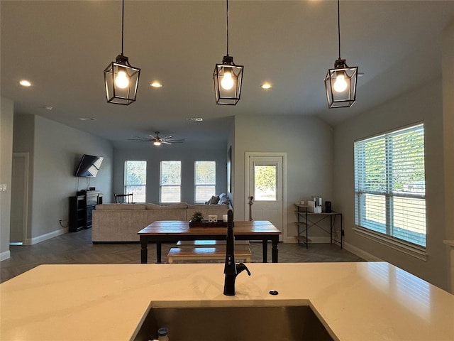 kitchen featuring ceiling fan, hanging light fixtures, and sink