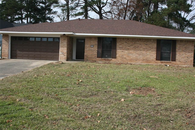 single story home with a front yard and a garage