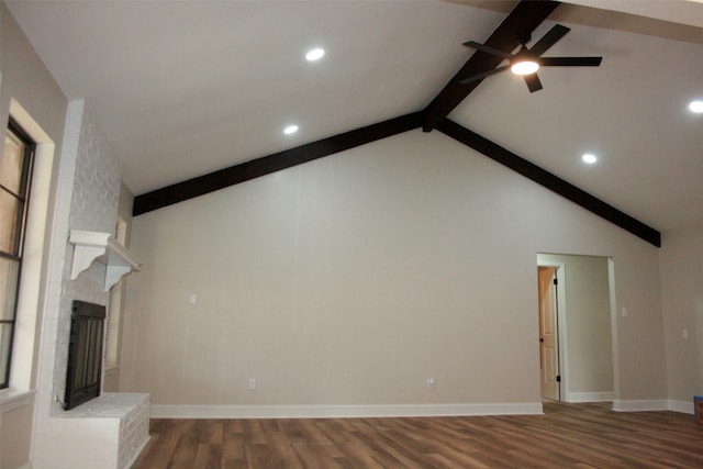 unfurnished living room featuring a brick fireplace, ceiling fan, beam ceiling, high vaulted ceiling, and dark hardwood / wood-style floors