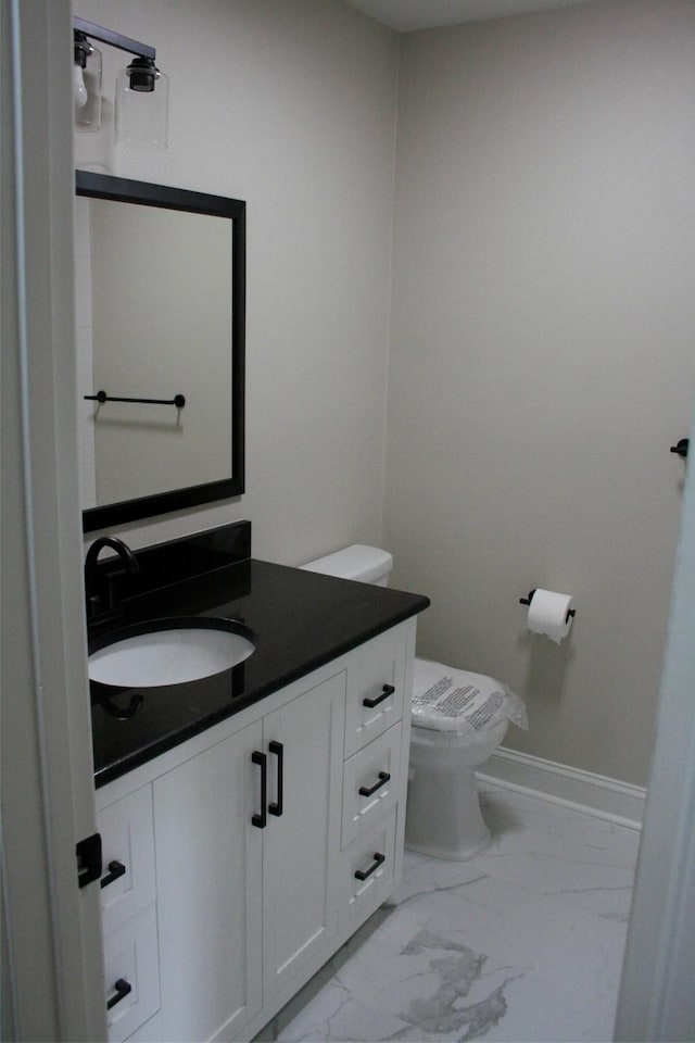 bathroom featuring vanity and toilet