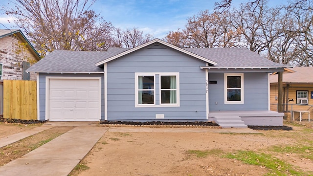 single story home with covered porch and a garage