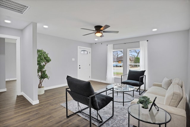 living area with dark wood-type flooring, recessed lighting, visible vents, and baseboards