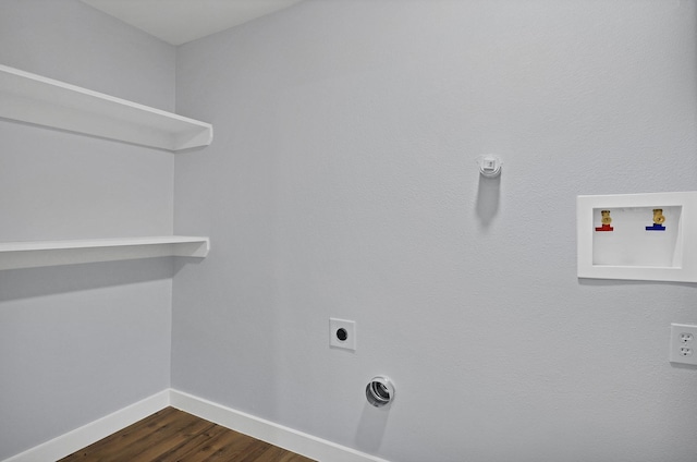 clothes washing area with hookup for an electric dryer, laundry area, dark wood-type flooring, washer hookup, and baseboards