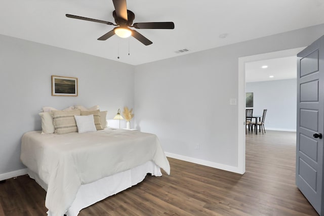 bedroom with baseboards, visible vents, ceiling fan, and wood finished floors